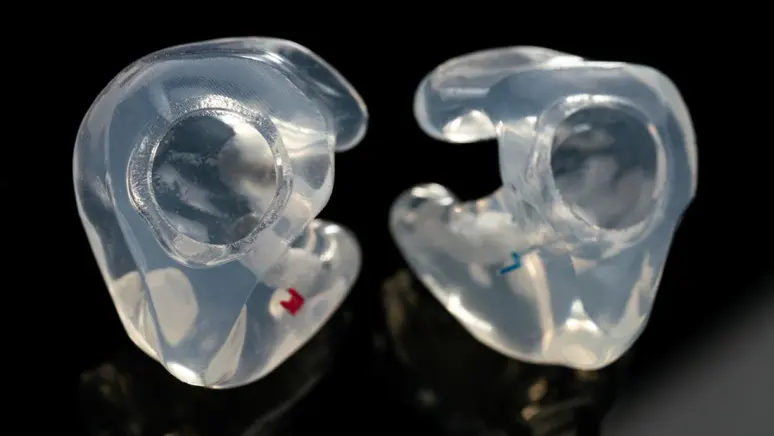 A custom-molded adapter that seals an H2O Audio player into the ear