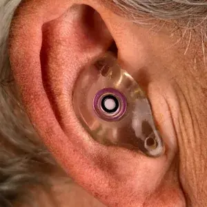 Custom filtered earplug molded and worn in the ear