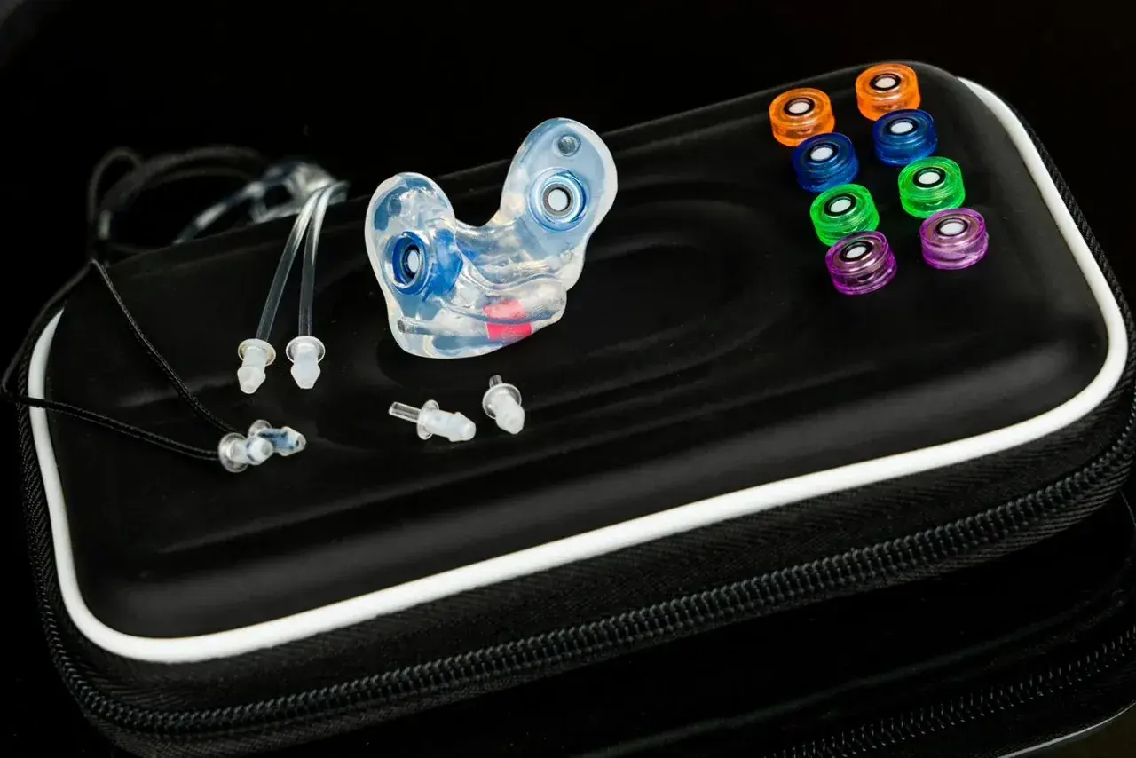 The One filtered custom earplugs — a hand-built, colour-moulded pair with an interchangeable filter