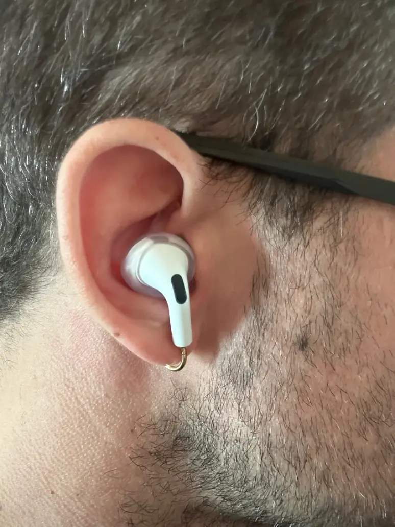A customer wearing an AirPod Pro with a custom adapter