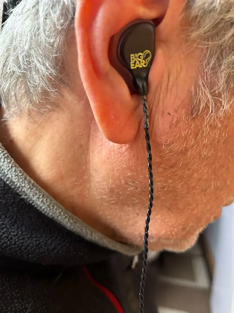 A customer wearing a Big Ear soft-shell custom in-ear monitor
