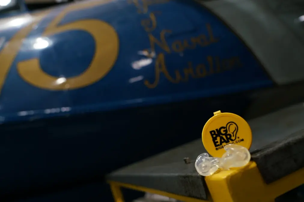 The Big Ear case and clear custom adapters beside a Naval Aviation aircraft