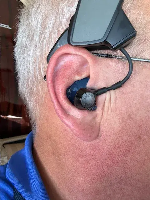 Close-up of a Bose ProFlight earbud seated in a custom Big Ear adapter