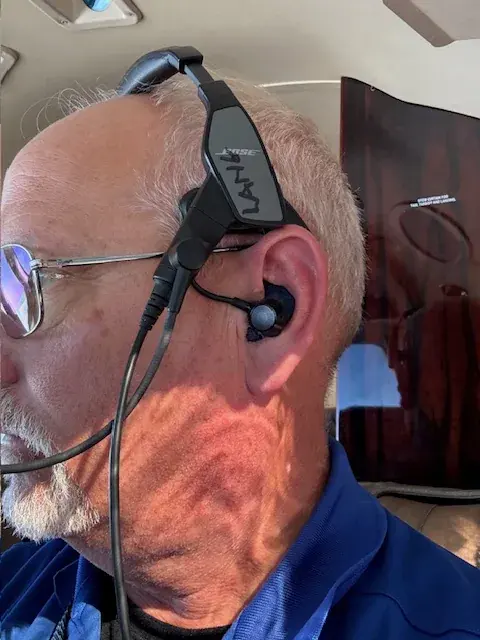 A pilot wearing the Bose ProFlight with a custom adapter