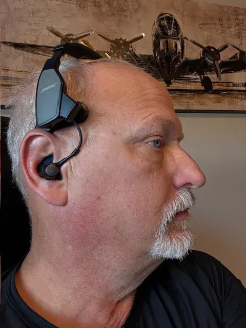 A customer wearing the Bose ProFlight headset with a custom Big Ear adapter