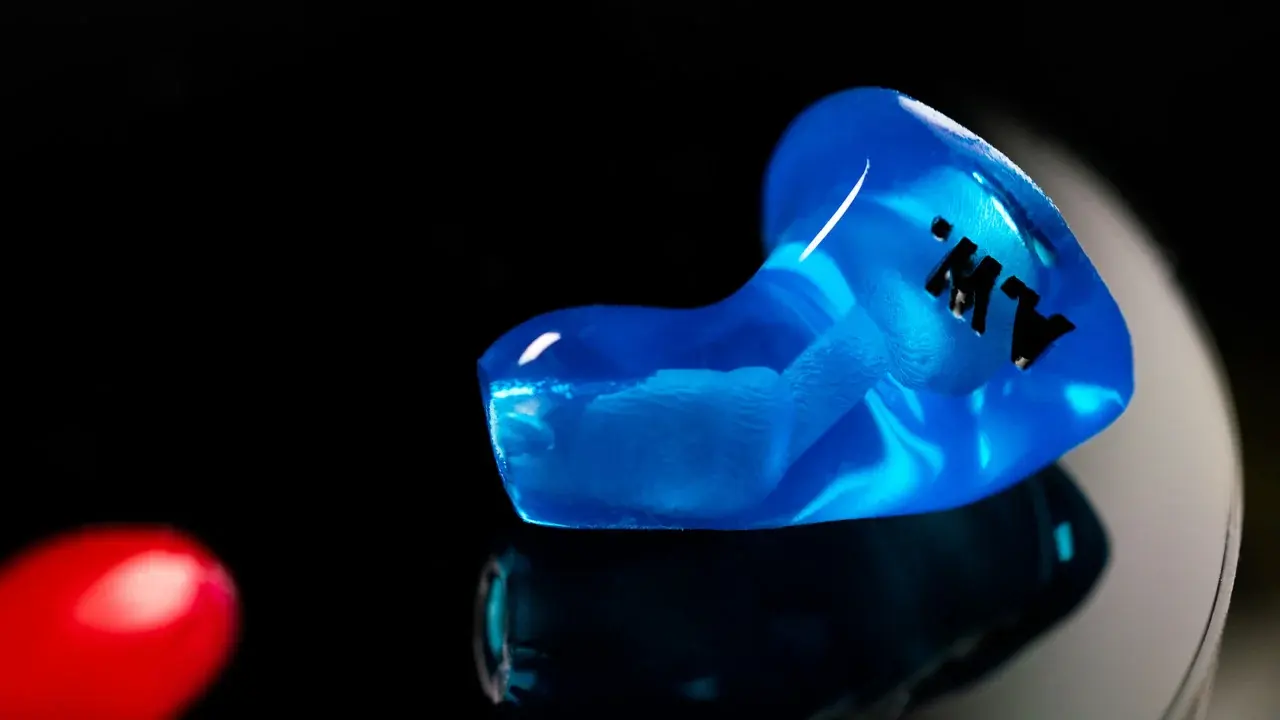 A blue custom CEP adapter, studio macro on black