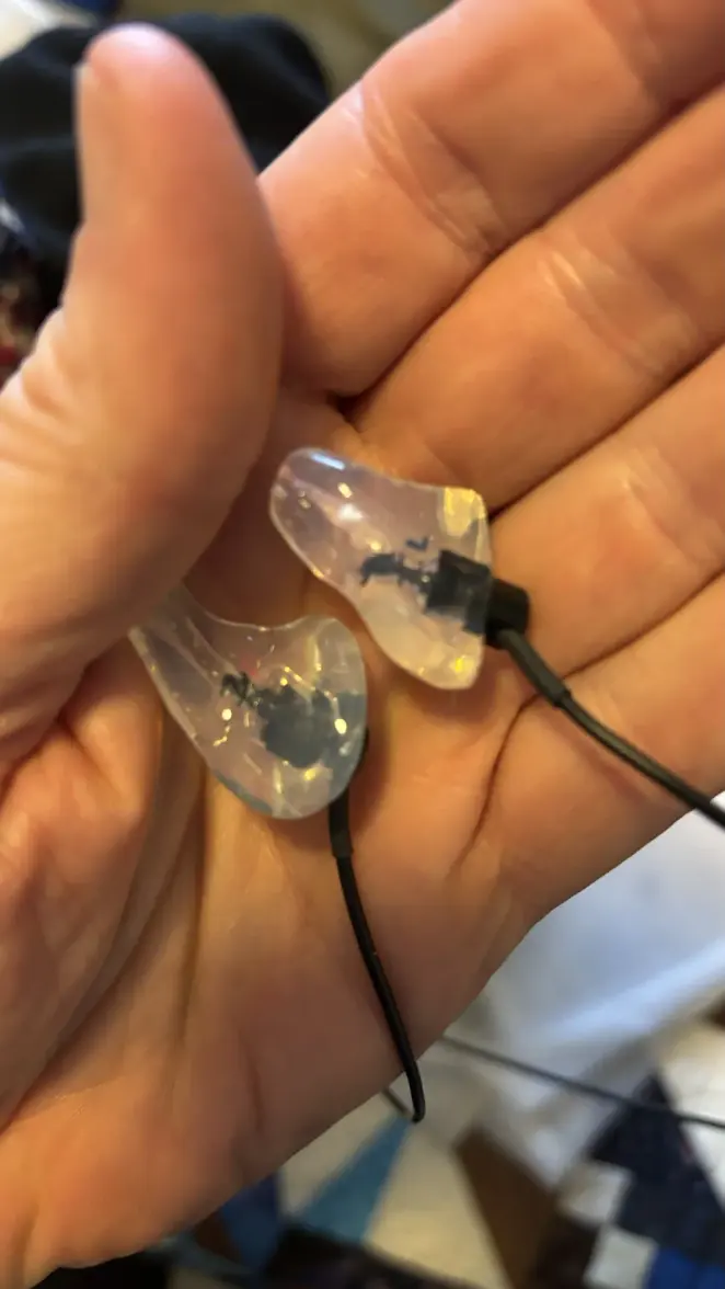 A matched pair of clear custom CEP adapters in hand
