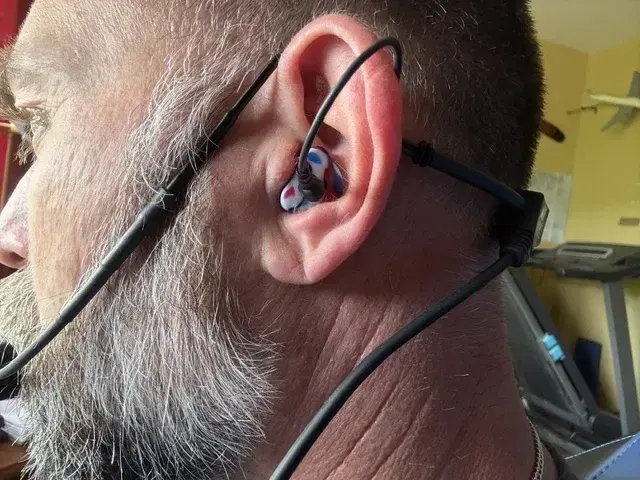 A customer wearing a red white and blue custom Clarity Aloft adapter