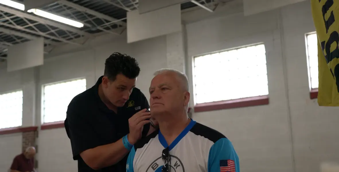 A Big Ear team member checking a customer’s ear