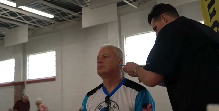 A Big Ear team member taking a custom ear impression for a rider